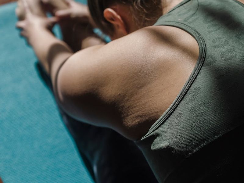 Detailed shot of a hand stretching towards a yoga mat