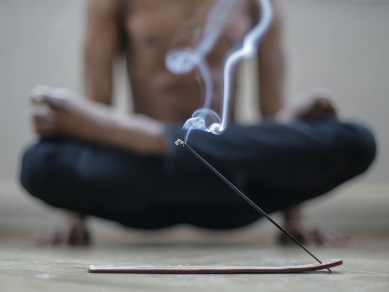 Person practicing yoga in a dark room with neon highlights